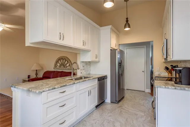 a kitchen with a sink stove and refrigerator