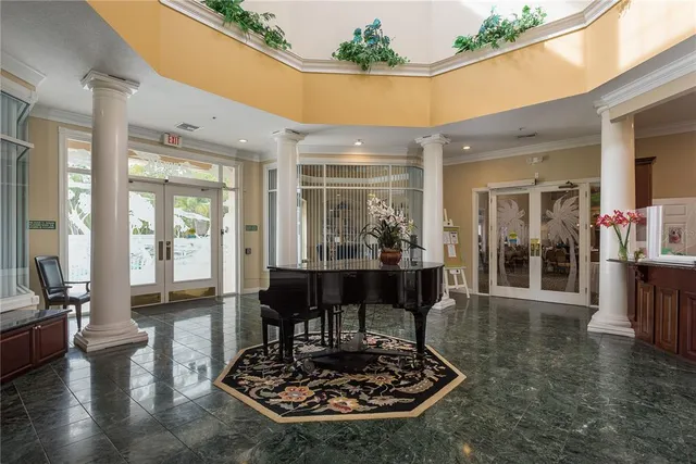 a living room with couch a dining table and a large window with garden view