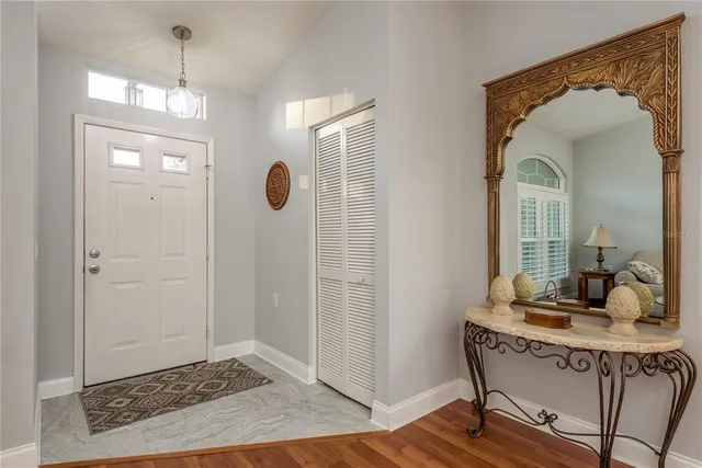 a view of a hallway with wooden floor and windows