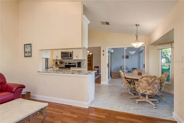 a dining room with furniture and window