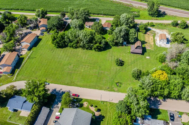 an aerial view of a house with a yard basket ball court and outdoor seating