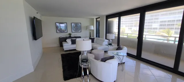 a dining room with furniture and a flat screen tv