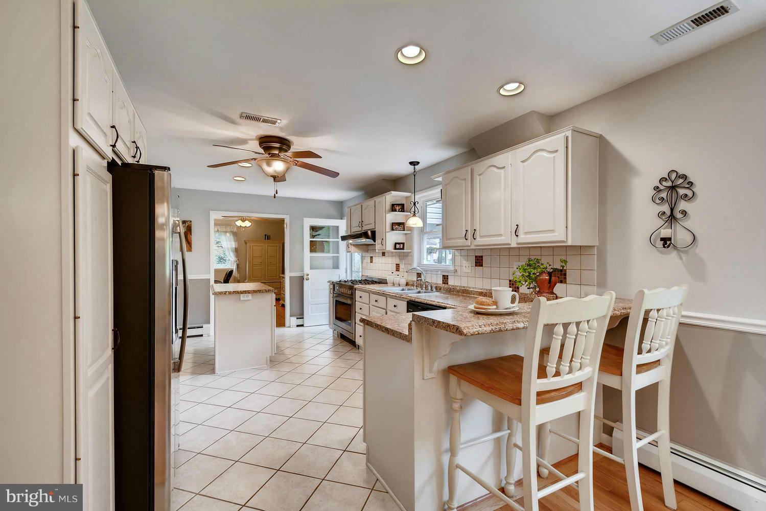 2705 Lawson Road Fallston, MD 21047 - Photo 12 of 30 a kitchen with white cabinets and stainless steel appliances