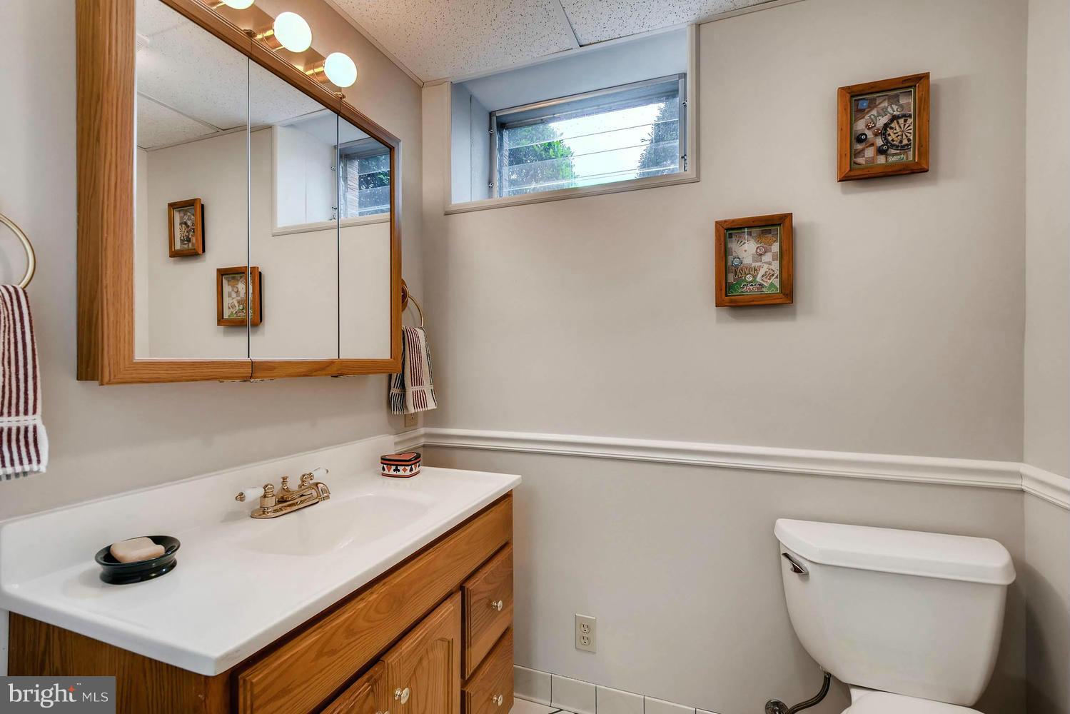2705 Lawson Road Fallston, MD 21047 - Photo 26 of 30 a bathroom with a sink a toilet and a mirror