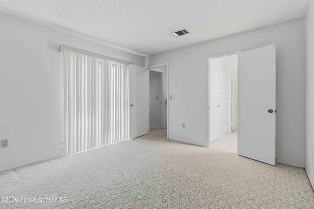 a view of an empty room and closet area