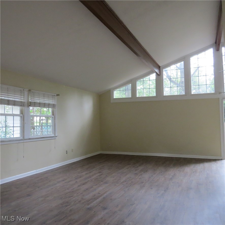 430 High Meadow Road Amherst, OH 44001 - Photo 12 of 29 Unfurnished room featuring lofted ceiling with beams and hardwood / wood-style floors