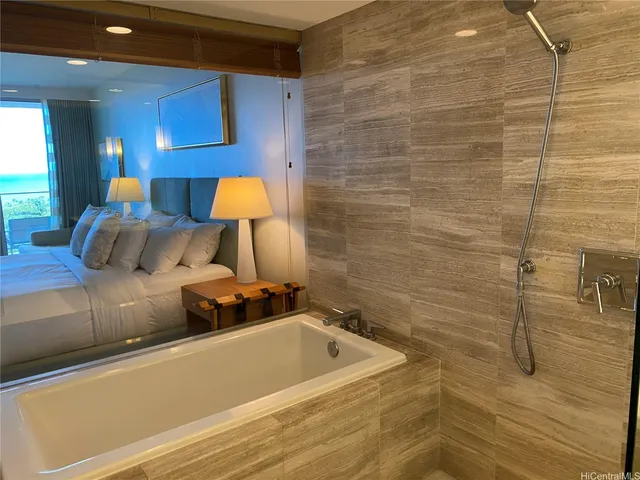 a bedroom with a bed and a lamp