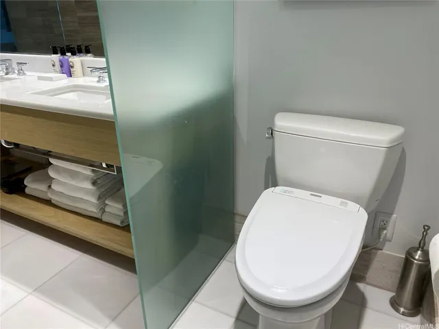 a white toilet sitting next to a bathroom sink