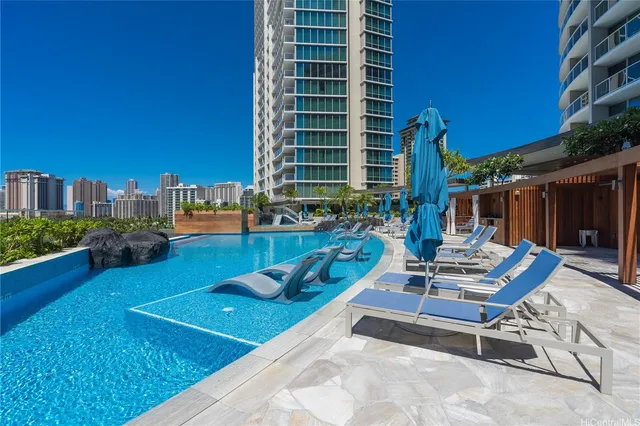 a room with gym equipment and large windows