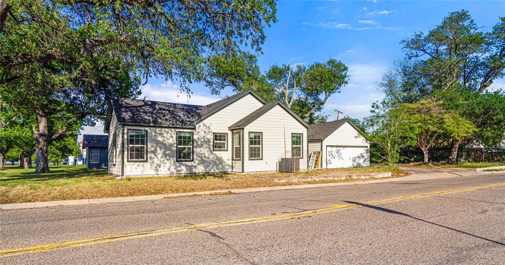 2928 Pine Avenue Waco, TX 76708 - Photo 23 of 24 a view of a white house with a large tree and plants