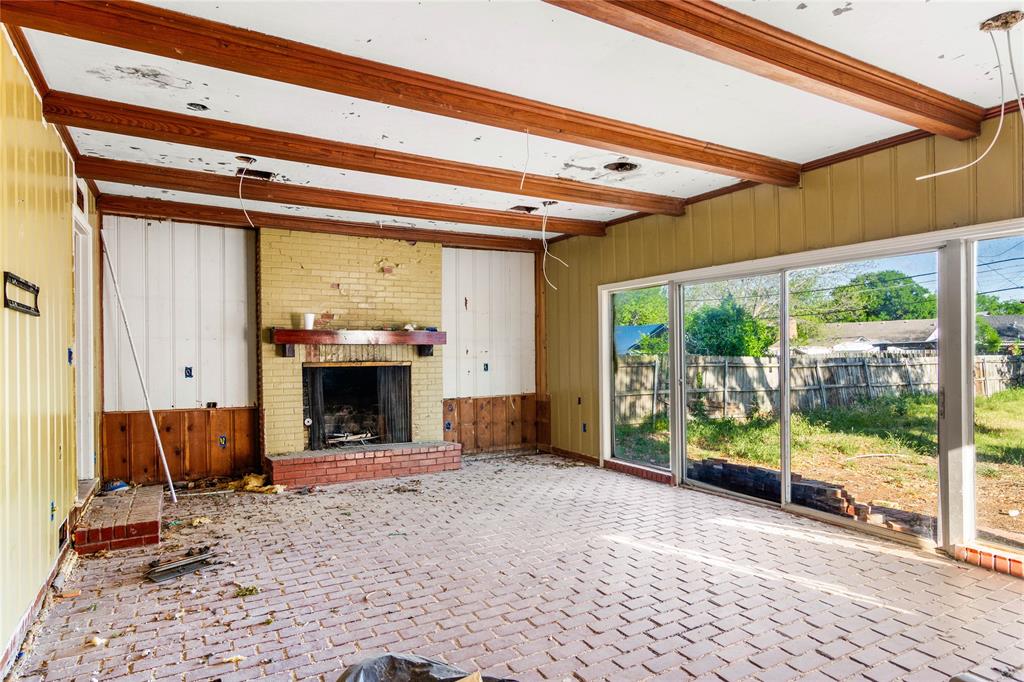 2928 Pine Avenue Waco, TX 76708 - Photo 9 of 24 a view of an empty room with a fireplace and a window