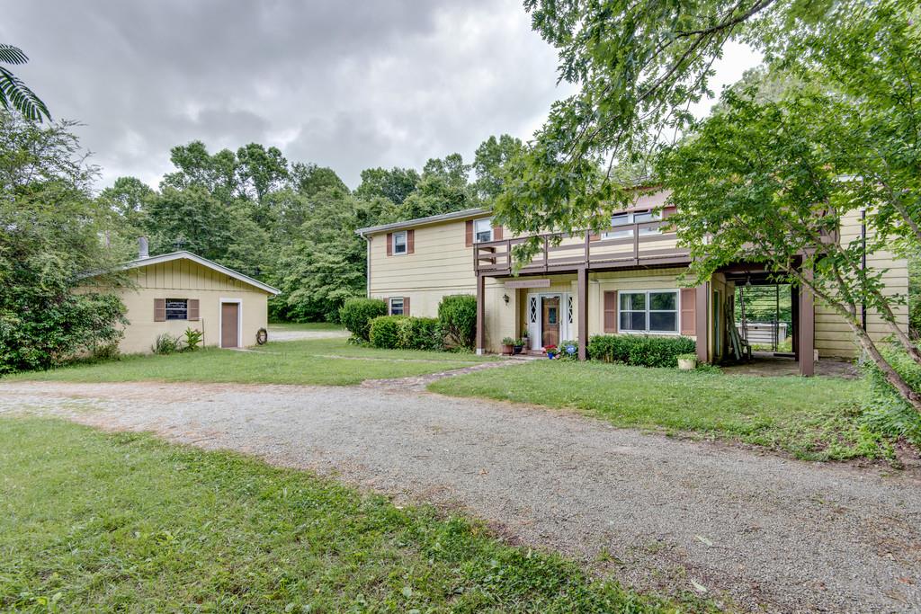 9794 Missionary Ridge Road Bon Aqua, TN 37025 - Photo 1 of 30 a front view of a house with a yard and trees