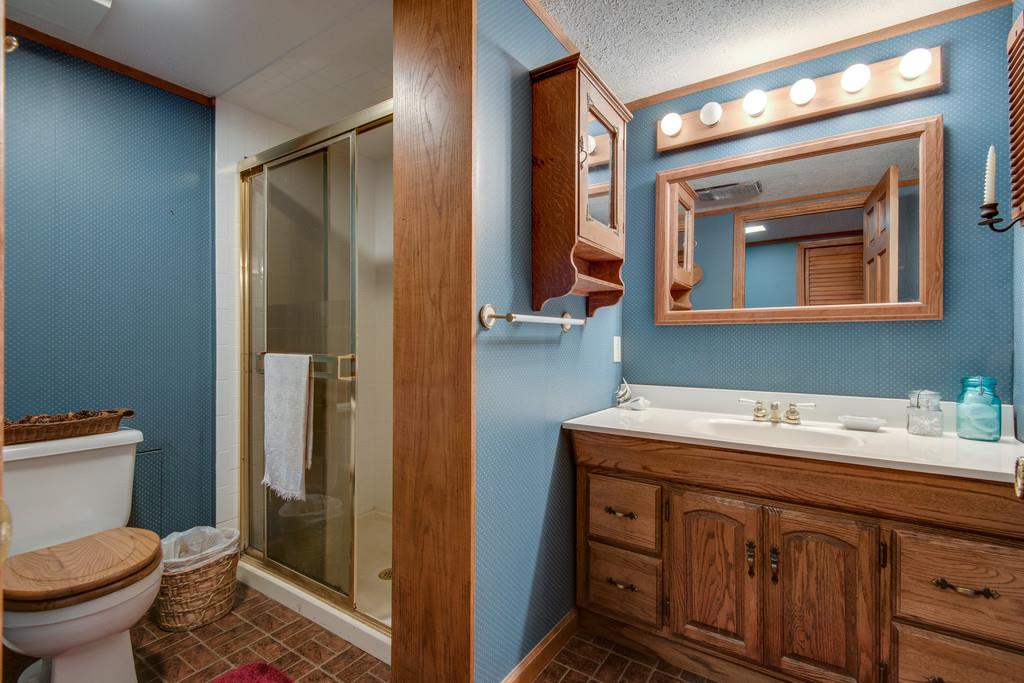 9794 Missionary Ridge Road Bon Aqua, TN 37025 - Photo 16 of 30 a bathroom with a sink a toilet and shower