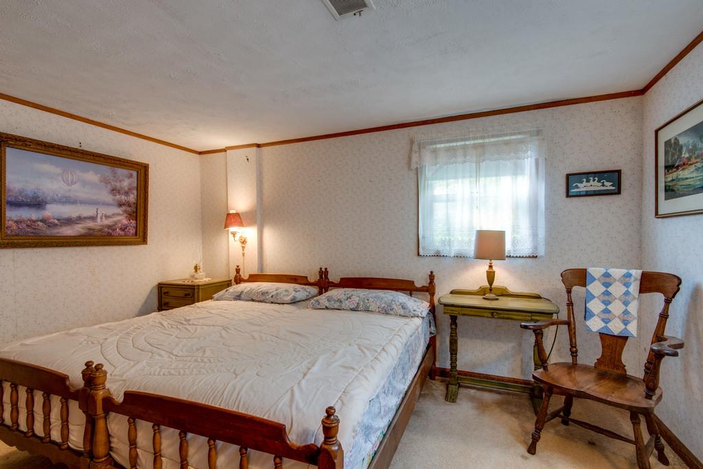 9794 Missionary Ridge Road Bon Aqua, TN 37025 - Photo 17 of 30 a bedroom with a bed and a table in it