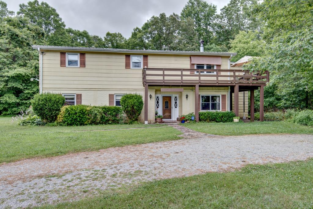 9794 Missionary Ridge Road Bon Aqua, TN 37025 - Photo 2 of 30 a view of a house with a yard and potted plants