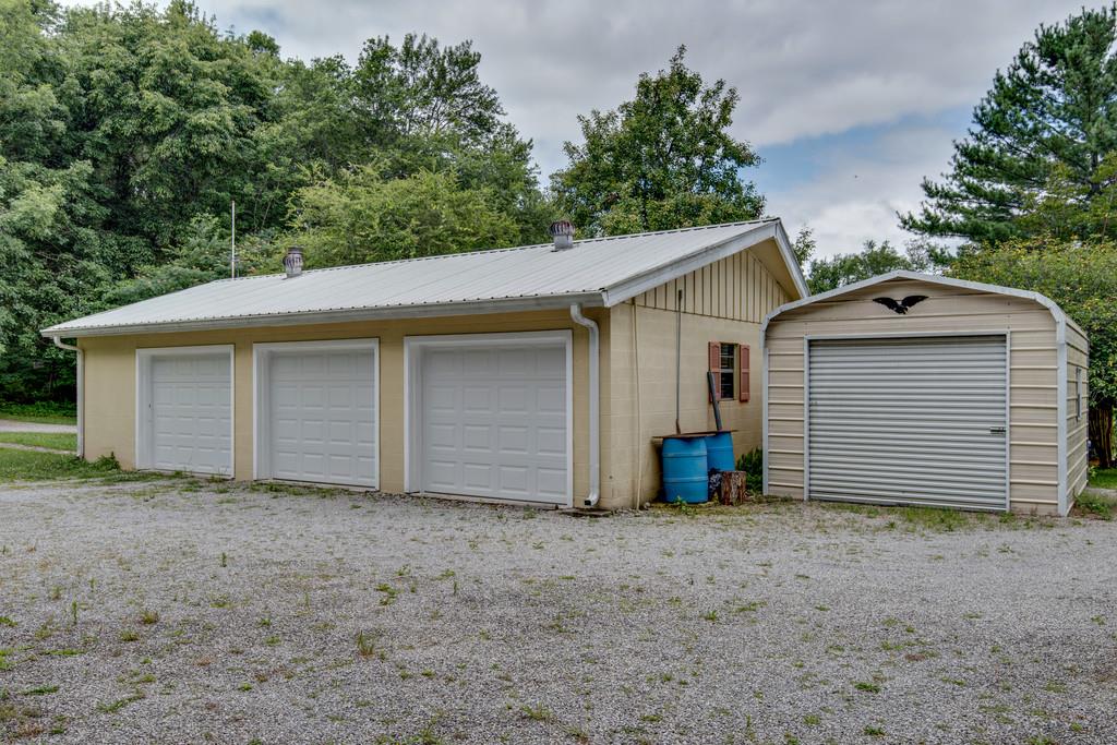 9794 Missionary Ridge Road Bon Aqua, TN 37025 - Photo 21 of 30 a view of a house with a yard and garage
