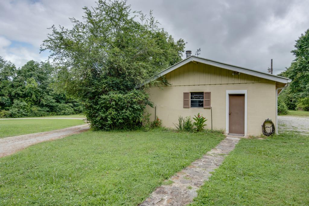 9794 Missionary Ridge Road Bon Aqua, TN 37025 - Photo 22 of 30 a front view of a house with garden