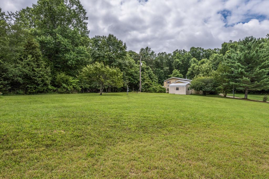 9794 Missionary Ridge Road Bon Aqua, TN 37025 - Photo 26 of 30 a view of a garden with a bench in a garden