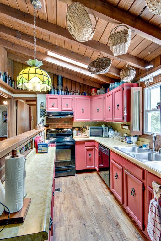 9794 Missionary Ridge Road Bon Aqua, TN 37025 - Photo 7 of 30 a large kitchen with stainless steel appliances granite countertop a stove a sink and a wooden cabinets