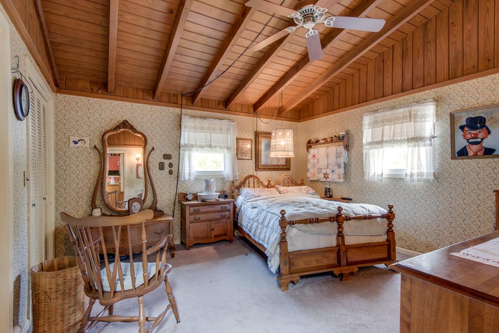 9794 Missionary Ridge Road Bon Aqua, TN 37025 - Photo 8 of 30 a bedroom with a bed a dresser and windows