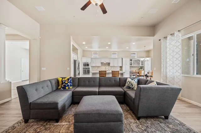 a living room with furniture and kitchen view
