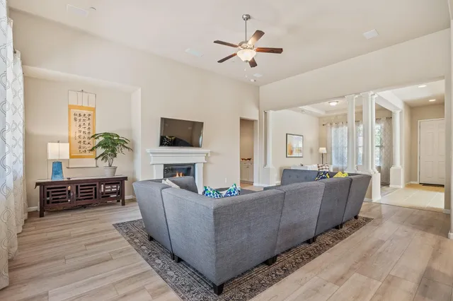 a living room with fireplace furniture and a flat screen tv