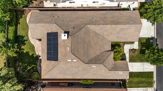 a aerial view of a house with large trees