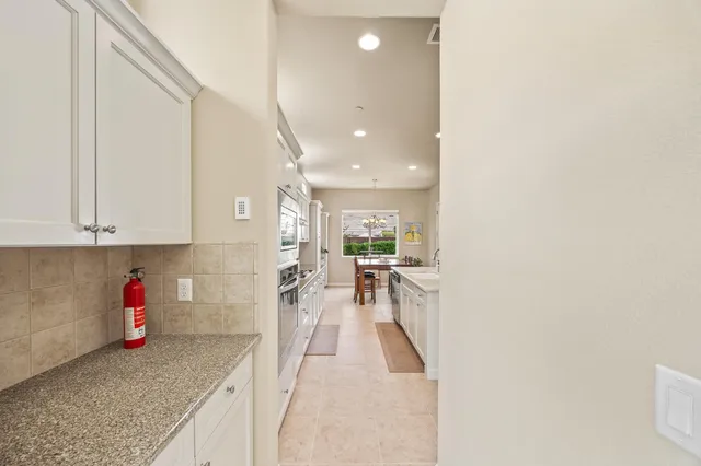 a kitchen with a table and chairs