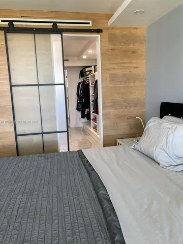a bedroom with a bed and a mirror