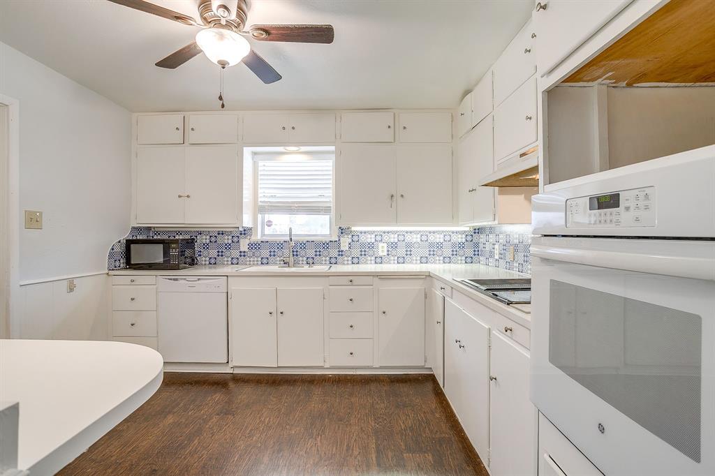 1900 Sutter Street, Unit C Fort Worth, TX 76107 - Photo 5 of 33 a kitchen with cabinets appliances a sink and a window