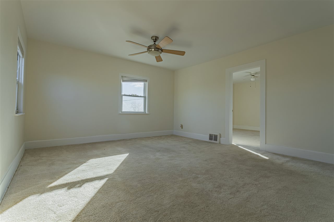 15283 Trask Bridge Road Pecatonica, IL 61063 - Photo 13 of 25 an empty room with windows and fan