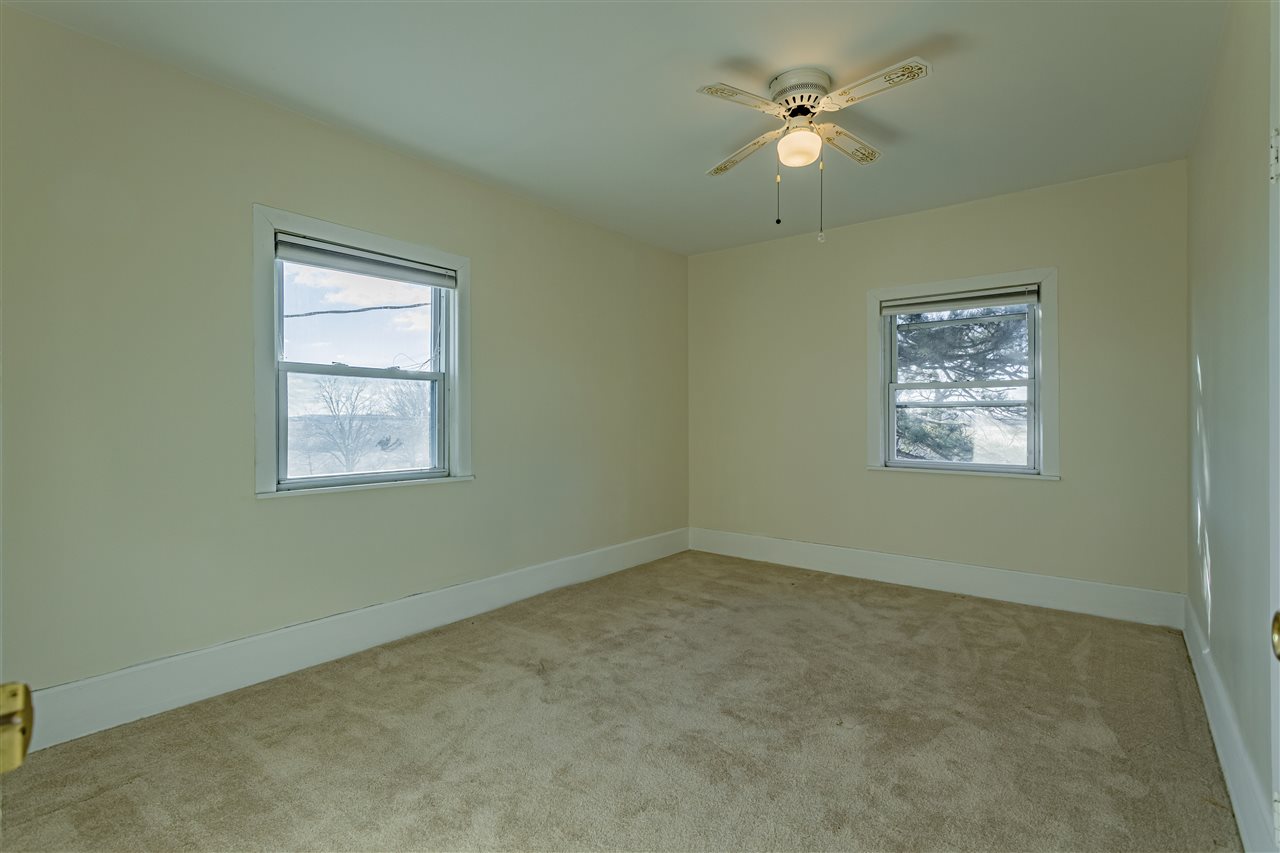 15283 Trask Bridge Road Pecatonica, IL 61063 - Photo 14 of 25 an empty room with a window and a ceiling fan