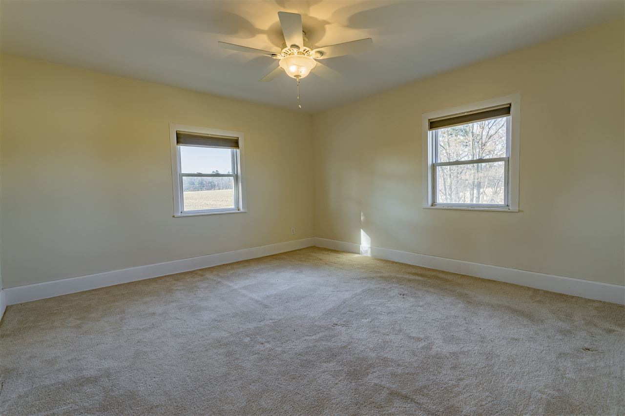 15283 Trask Bridge Road Pecatonica, IL 61063 - Photo 15 of 25 an empty room with windows and fan