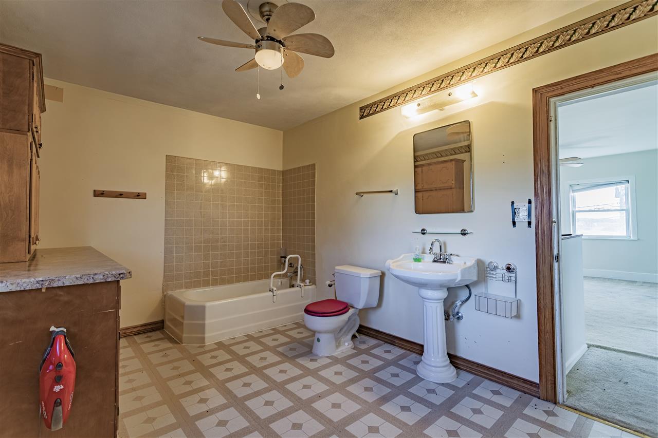15283 Trask Bridge Road Pecatonica, IL 61063 - Photo 16 of 25 a bathroom with a sink a toilet and shower