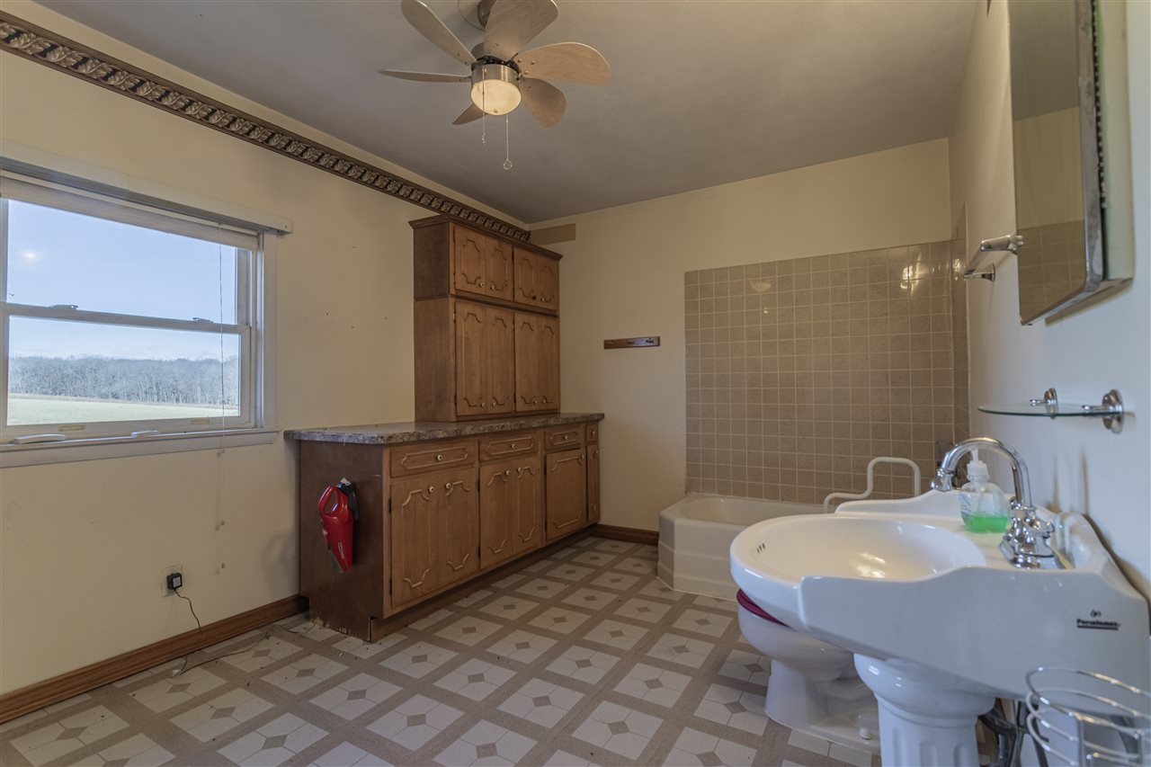15283 Trask Bridge Road Pecatonica, IL 61063 - Photo 17 of 25 a bathroom with a sink and a mirror