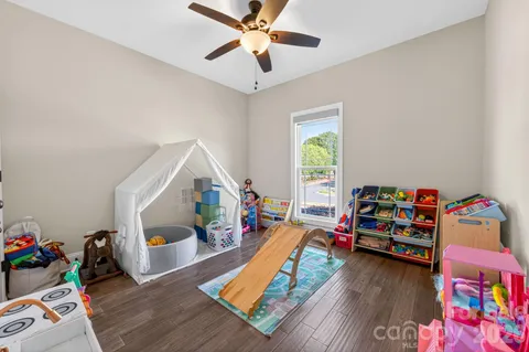 a children room with toys and a wooden floor