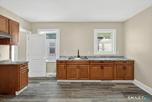 a spacious bathroom with a granite countertop sink and a mirror