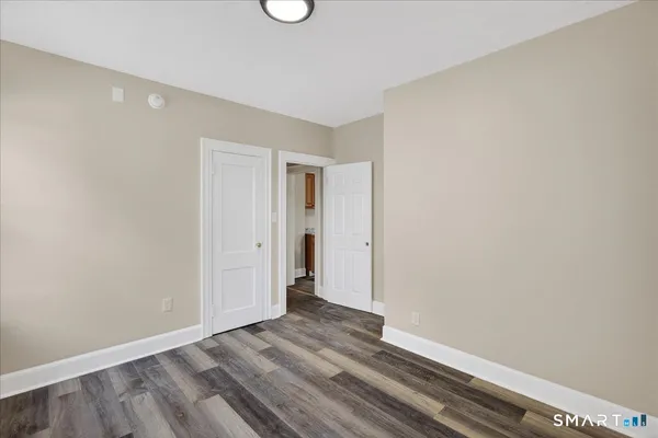 a view of an empty room with wooden floor