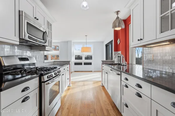 a kitchen with stainless steel appliances granite countertop a stove and a sink