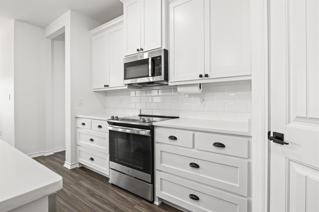 103 St James Mount Mount Pleasant, TX 75455 - Photo 14 of 39 a kitchen with stainless steel appliances white cabinets and a stove