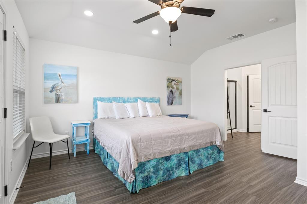 103 St James Mount Mount Pleasant, TX 75455 - Photo 26 of 39 a bedroom with a bed and a chandelier