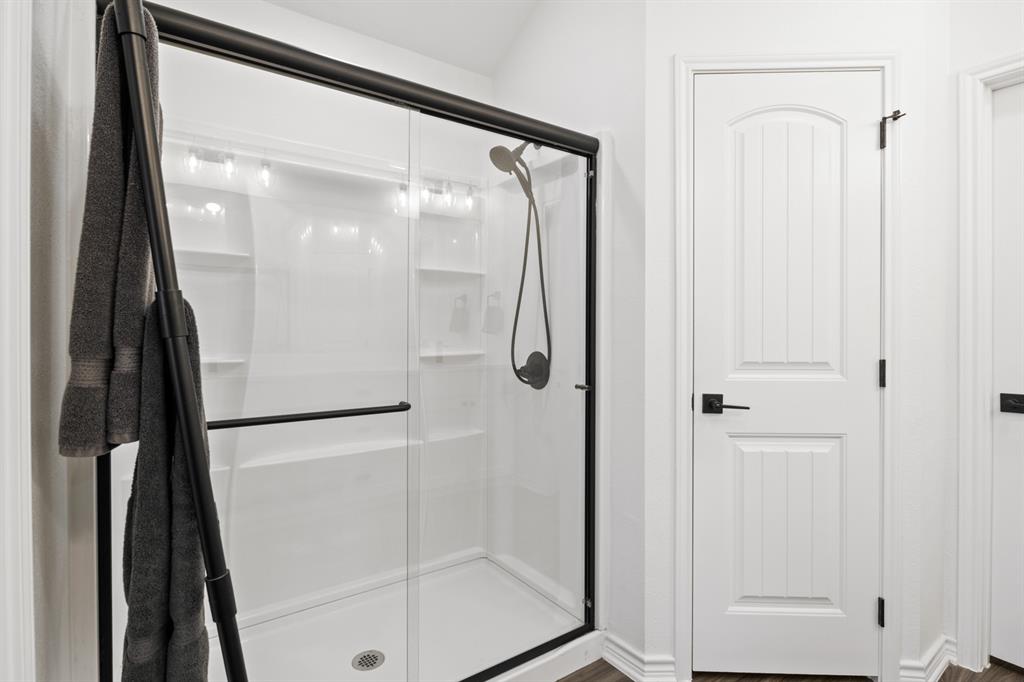 103 St James Mount Mount Pleasant, TX 75455 - Photo 28 of 39 a bathroom with a glass shower door