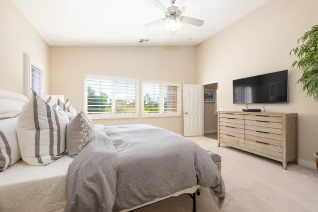 a bedroom with a bed and flat screen tv