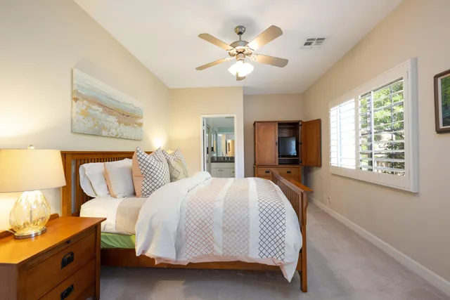 a bedroom with a large bed and a window