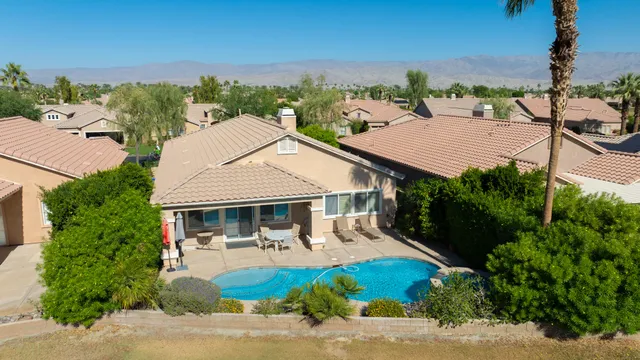 an aerial view of a house with yard and green space