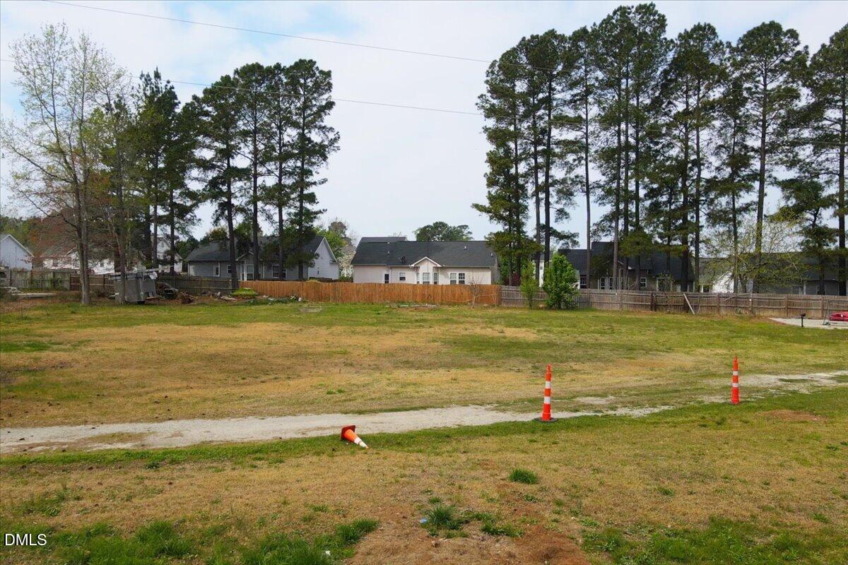 7201 Applecreek Court Raleigh, NC 27610 - Photo 15 of 17 a view of a swimming pool with a yard and palm trees