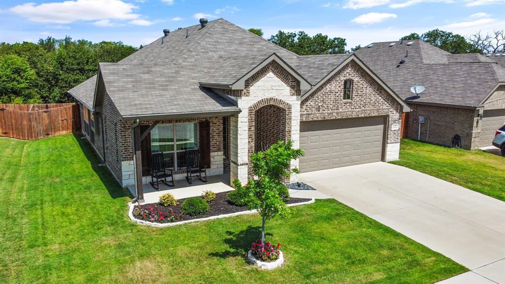 2504 Doe Run Weatherford, TX 76087 - Photo 1 of 1 a view of a house with brick walls and a yard with plants