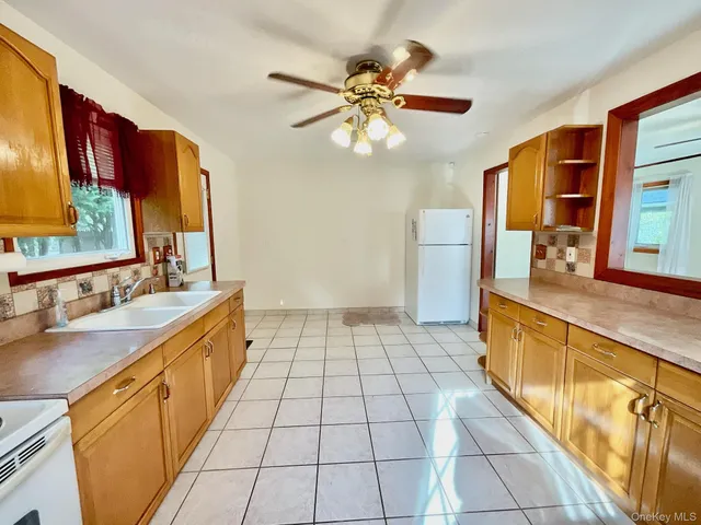 a large kitchen with a sink and cabinets