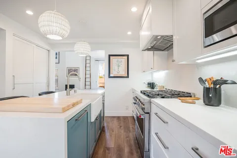 a kitchen with a sink a stove and cabinets
