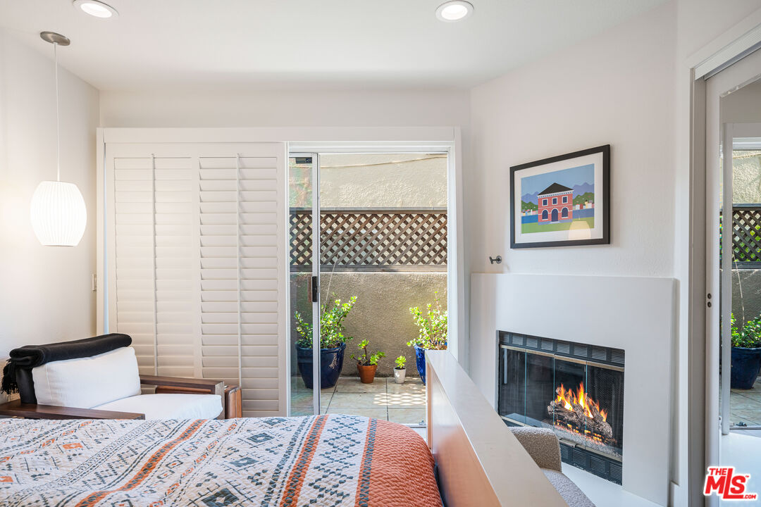 2808 Arizona Avenue, Unit 3 Santa Monica, CA 90404 - Photo 9 of 20 a bedroom with a bed and a fireplace